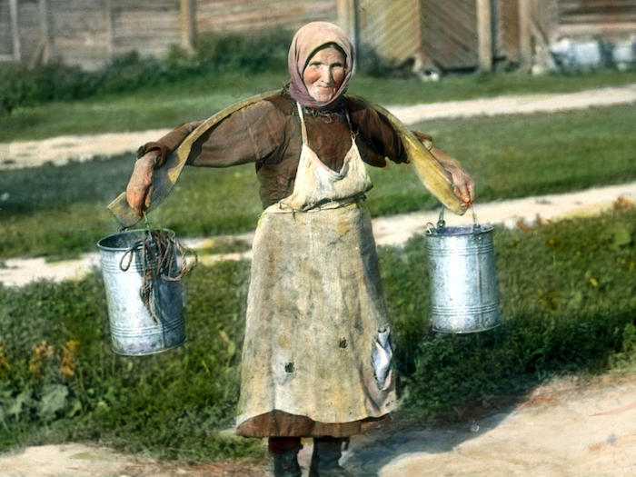 Woman carrying buckets